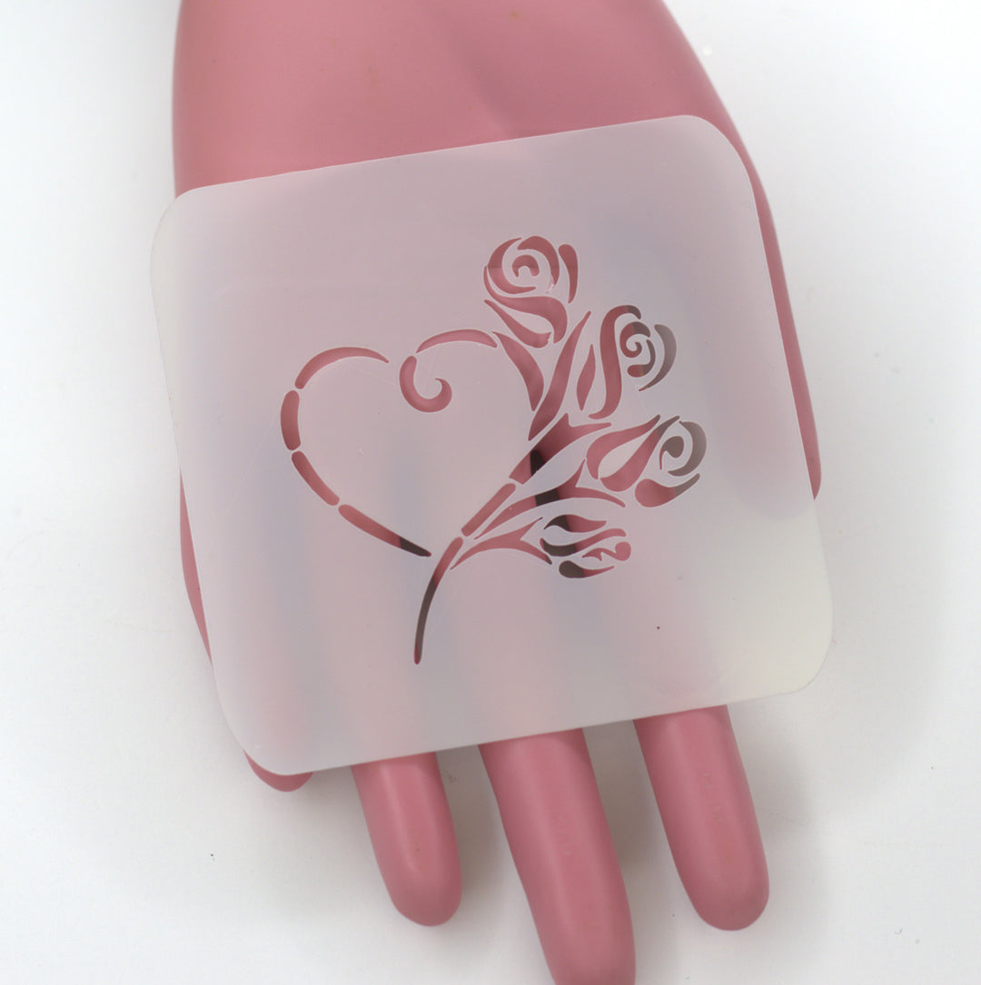 rose buds on heart stencil held by pink hand