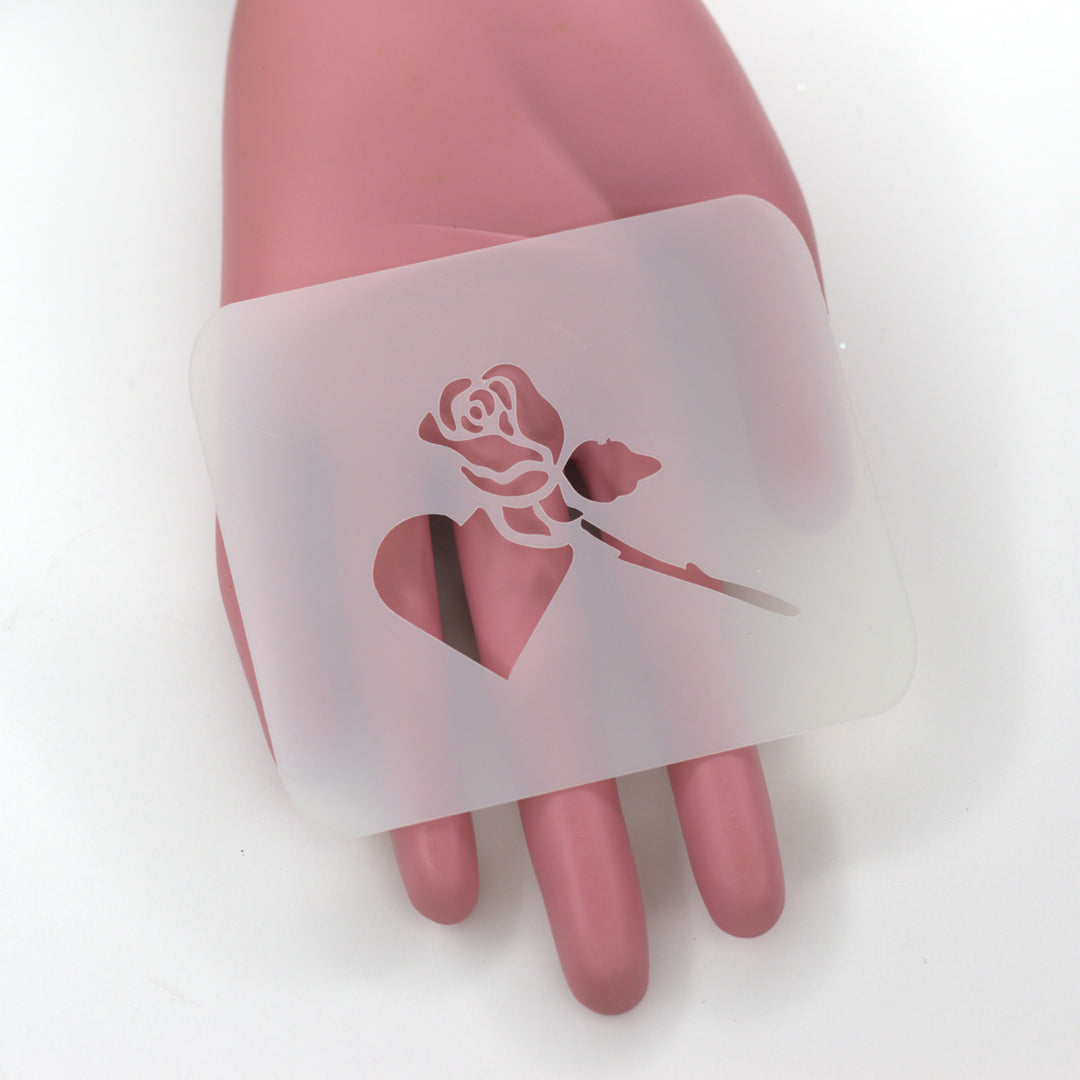 PET stencil with heart and rose bud cut design on pink hand
