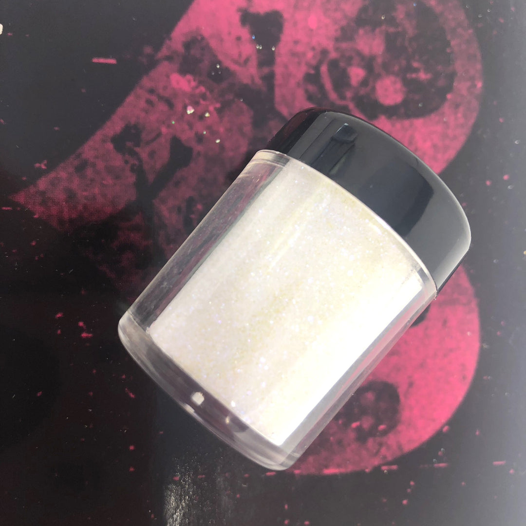 ultra fine cosmetic face painting glitter in clear jar laying on its side